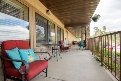 Patio seating area with colorful chairs and decorative pillows