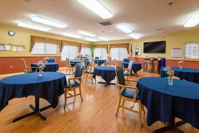 Bright common area with tables and chairs set up