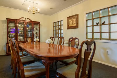Elegant dining room with a large wooden table and chairs