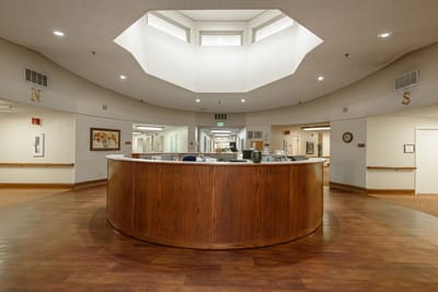Lobby area of a nursing home with a circular reception desk