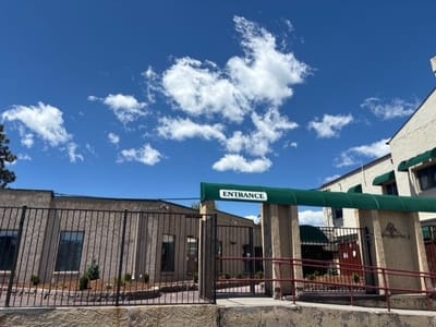Exterior view of the facility entrance with a blue sky