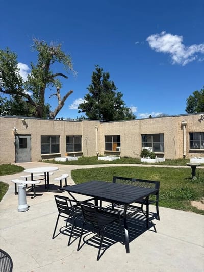 Outdoor seating area with tables and chairs