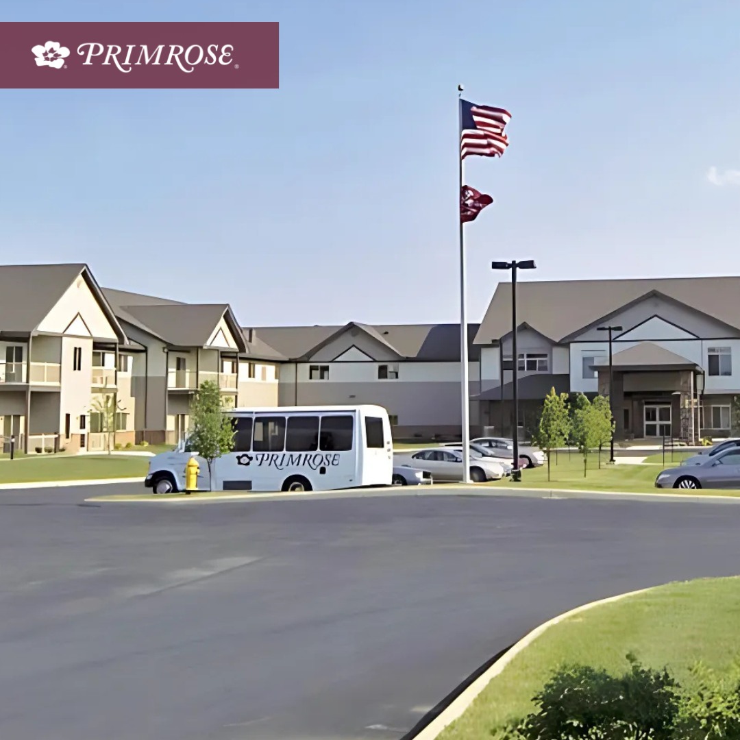 Facility logo with exterior view of Primrose Retirement Community