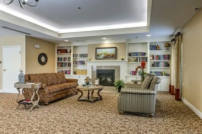 A cozy common area with seating and bookshelves