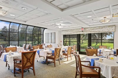 Bright dining room with tables set for breakfast