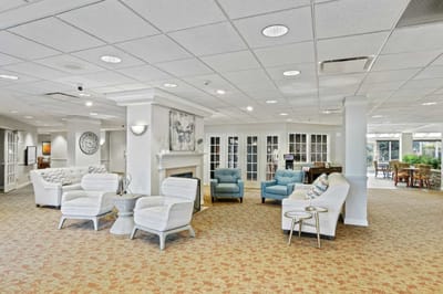 Bright common area with seating and fireplace.