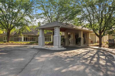 Entrance of a senior living facility with trees