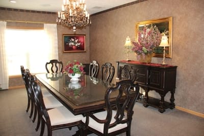 Elegant dining area with chandelier and floral decor