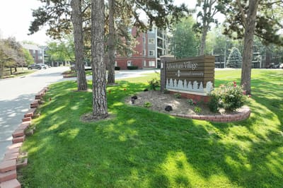 Exterior view of Arboretum Village sign and landscaped grounds