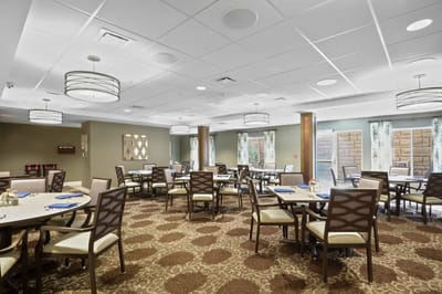 Bright dining room with tables set for meals