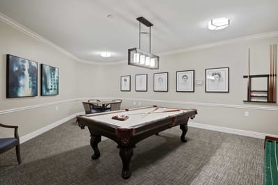 A well-lit common area with a billiard table