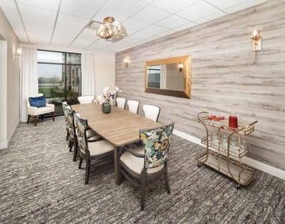 Bright dining room with a long wooden table and elegant decor