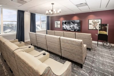 Bright common area with seating and a popcorn machine