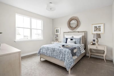 Well-decorated resident room with bed and window