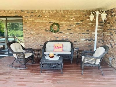 Cozy outdoor seating area with a welcome pillow