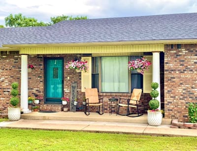 Welcoming porch area with flowers and seating