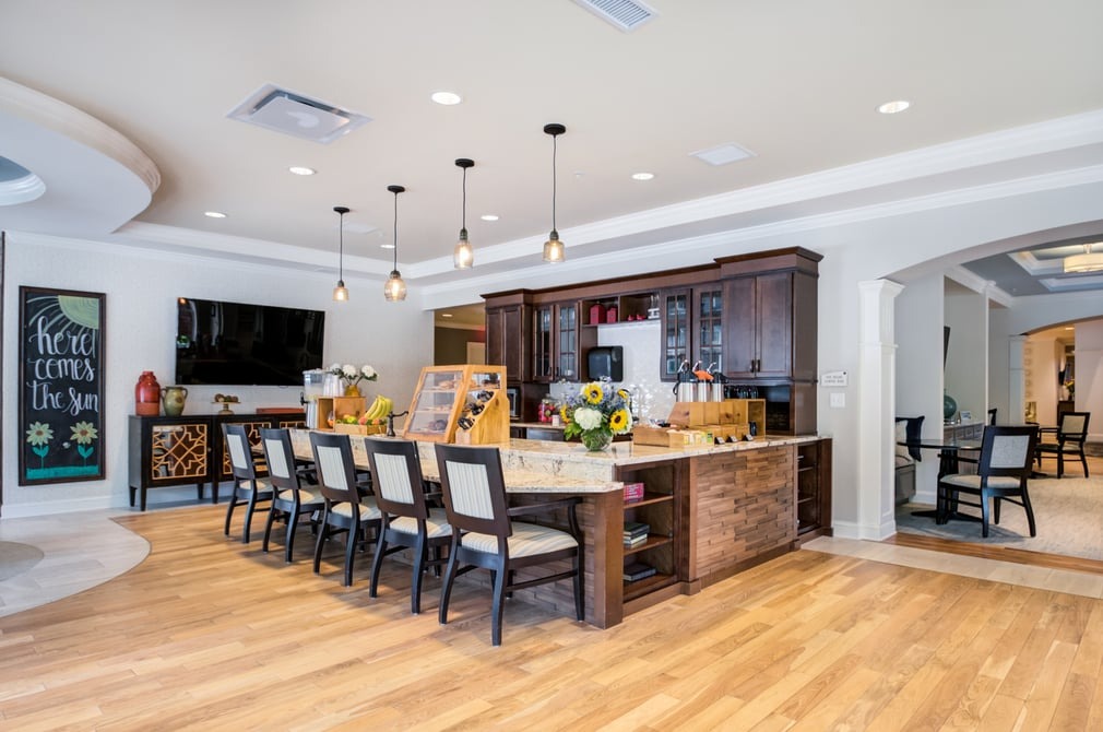 Bright common area with seating and a kitchen island