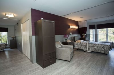 Private resident room with two beds and seating area