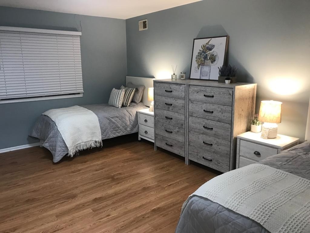 Well-furnished twin bedroom in a senior living facility