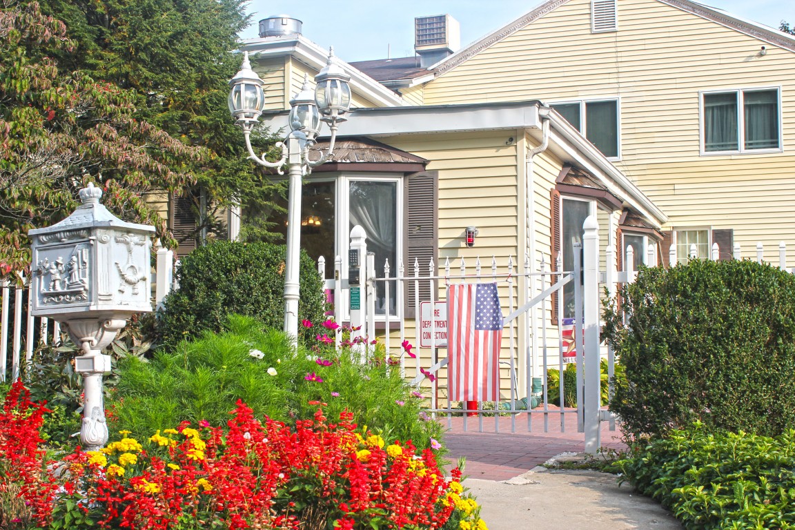Charming exterior of a senior living facility with flowers