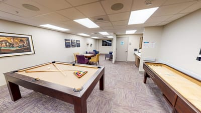 Interior activity room with billiards and shuffleboard