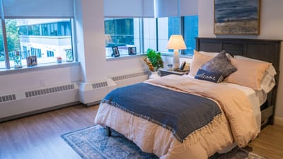 Cozy private bedroom with natural light and decor
