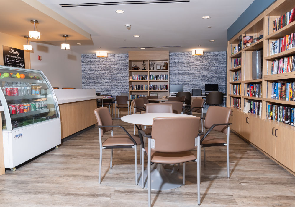 Bright common area with bookshelves and seating