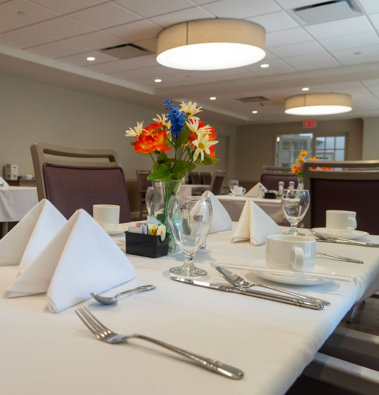 Dining table set for a meal with flowers