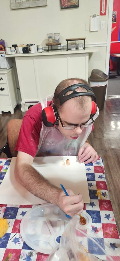 Resident engaged in an art activity in the facility's interior