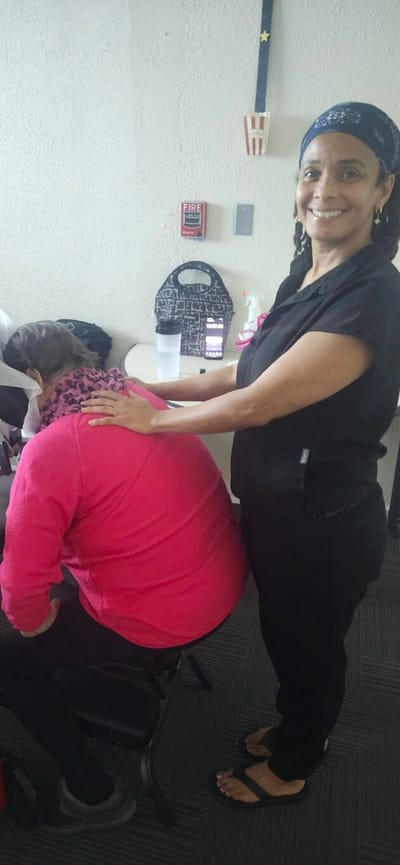 Staff member providing a massage to a resident