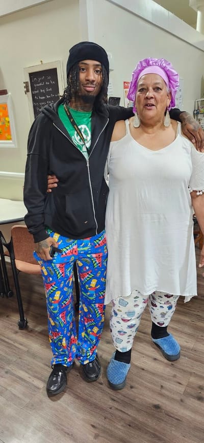 Two residents posing in a communal area