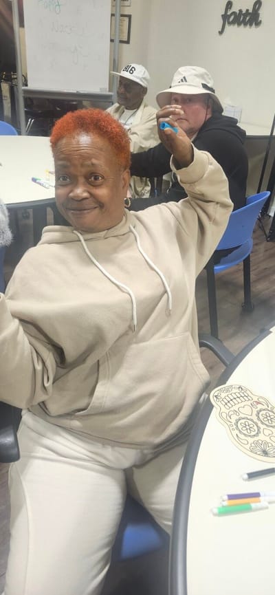 Resident engaging joyfully during an activity.