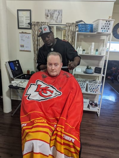 Resident getting a haircut in a common area