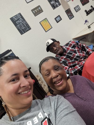 Residents and staff smiling in a social setting