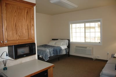 A cozy resident room with a bed and window
