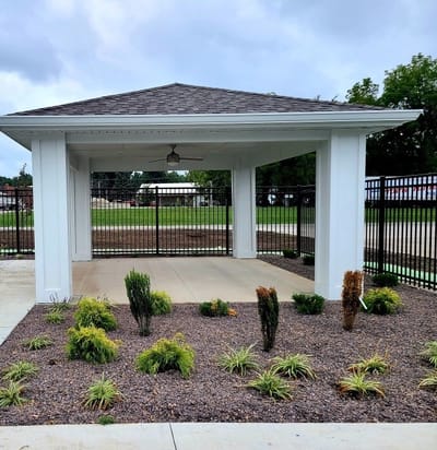 Covered outdoor space with landscaping and seating area