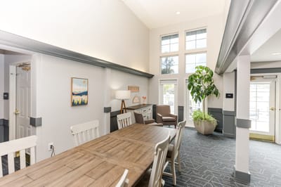 Bright common area with seating and large windows