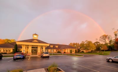 Building exterior with a rainbow in the background