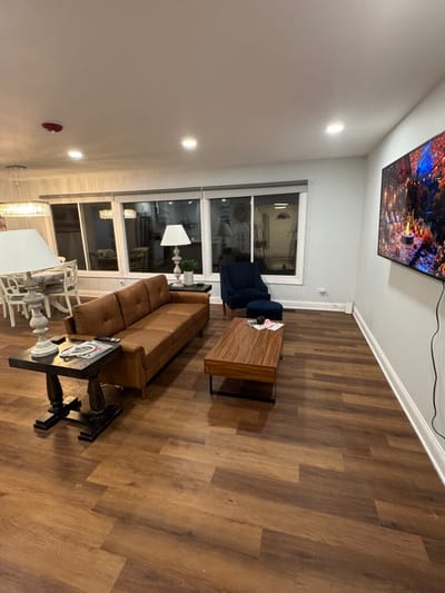 Bright common area with seating and a TV