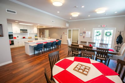 Bright common area with dining tables and chairs