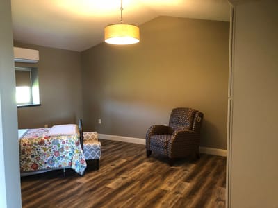 Bright interior of a resident's room with floral bedding