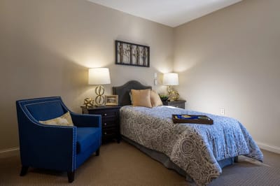 Cozy resident room with a bed and chair