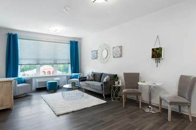 Brightly furnished resident room with modern decor