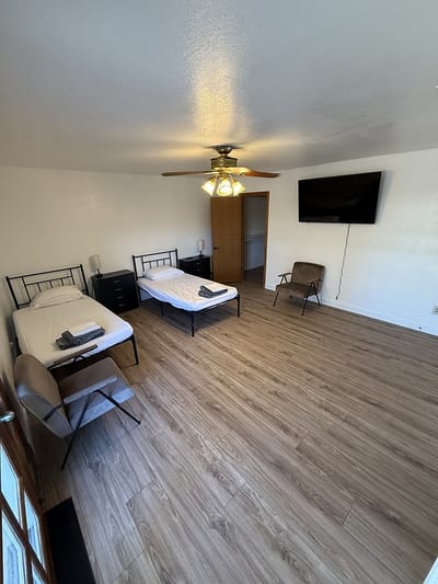 Simple resident room with two beds and basic furnishings
