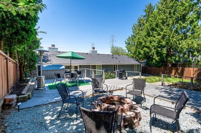Outdoor seating area with a fire pit and umbrellas