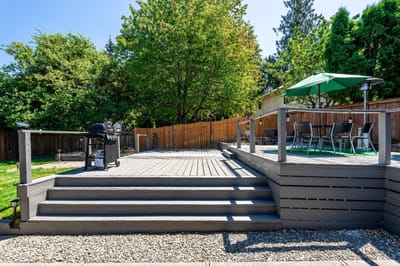 Spacious outdoor deck area with seating and grill