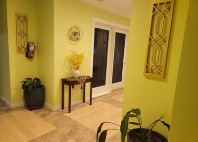 Brightly lit interior hallway with plants and decorations
