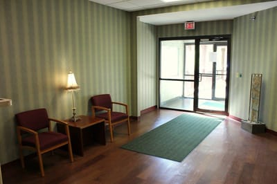 Bright entryway with seating and a lamp