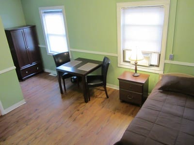 Cozy private room with a bed and table
