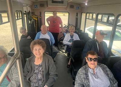 Residents enjoying a ride on a facility shuttle bus
